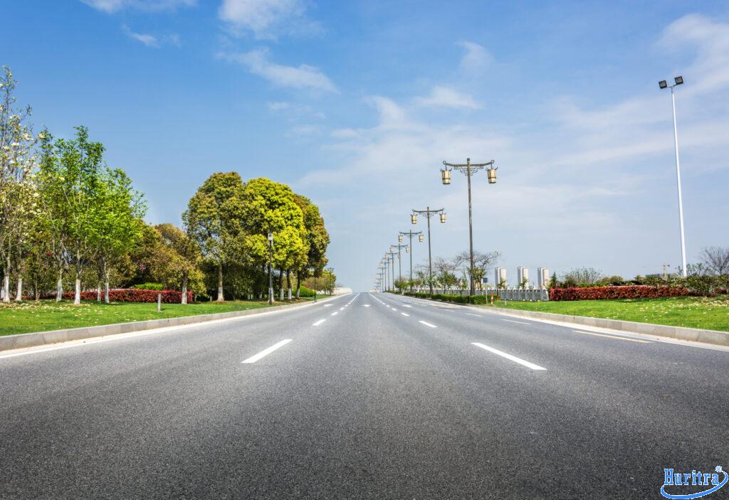 asphalt road with trees lampposts scaled